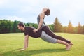 People practice acro yoga outdoors healthy lifestyle