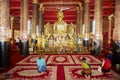 People pray in Wat Mai Suwannaphumaham Buddhist temple in Luang Prabang Laos.