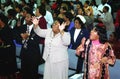 Several peoole in worship to God in a chur ch service