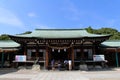 People praying in front of wooden Japanese temple in Yamaguchi.