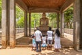 People praying at the granite Samadhi Buddha Statue in Mahamevnawa Park, Anuradhapura, Sri Lanka