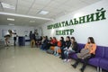 People, pregnant women and relatives, sitting in chairs waiting in a reception hall of a maternity hospital Royalty Free Stock Photo