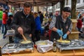 People during the preparation of traditional melted cheese at En