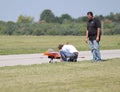 People Prepare Model Airplane for flight