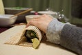 People preparing a rool maki `nori maki zushi`