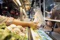 People in a protective mask,buying food in the food court at the mall after Coronavirus quarantine or Covid-19 with plastic shield