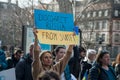 People protesting against the war with ukrainian flags with text disconnect russia from swift