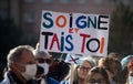 People protesting for the hospital with text in french : soigne et tais toi, in english : take care and shut up Royalty Free Stock Photo