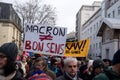 people protesting in the street with placard in french Macron different de bon sens, in