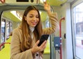 People on public transport. Beautiful young business woman reading message on her smart phone on the tram Royalty Free Stock Photo