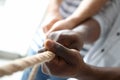 People pulling rope together, closeup of hands Royalty Free Stock Photo