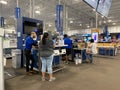 People purchasing electronics at a Best Buy sales counter in Orlando, Florida