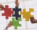 People Put Multicolored Jigsaw Puzzle Together. Royalty Free Stock Photo
