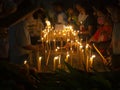 People putting burning incense and candle into pots in Makha Bucha Day