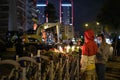 People putting Carnation flowers and lighting candles in memory of those who lost their lives on the earthquake 30 October 2020 on