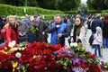 People putting flowers to the Eternal Flame in the Glory park, celebrating the Victory Day