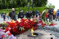 People putting flowers to the Eternal Flame in the Glory park, celebrating the Victory Day