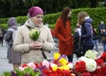 People putting flowers to the Eternal Flame in the Glory park, celebrating the Victory Day. Kyiv, Ukraine