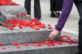 People putting poppy flowers on Tomb of the Unknown Soldier in Ottawa, Canada on Remembrance Day.