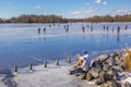 People putting on their skates at the shore of lake Paterswolde in Groningen
