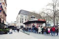 People queue for buying tickets from TKTS, the official London theatre ticket booth located at Leicester Square