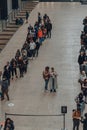 People queue inside Turbine Hall to scan QR codes needed to enter Tate Modern museum, London, UK Royalty Free Stock Photo