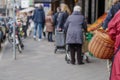 People queue and social distancing outside in front of food stall and supermarket during quarantine for COVID-19 virus in Europe. Royalty Free Stock Photo