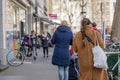 People queue and social distancing outside in front of food stall and supermarket during quarantine for COVID-19 virus in Europe.