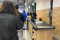 People queuing at a modern supermarket checkout Royalty Free Stock Photo