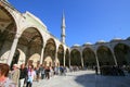 People queuing in mosque courtyard