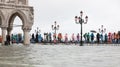 People with rain gear walking on the elevated walkway in the sub Royalty Free Stock Photo