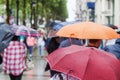 People with rain umbrellas in the rainy city