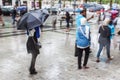 People with rain umbrellas in the rainy city