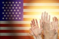 People raising hands and American flag on background. Patriotic concept Royalty Free Stock Photo