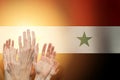 People raising hands and flag Syria on background. Patriotic concept