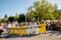 People rally for action on climate change yellow placard