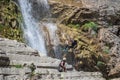 People rappelling in an impressive waterfall