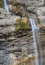 People rappelling in an impressive waterfall