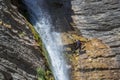 People rappelling in an impressive waterfall