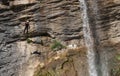 People rappelling in an impressive waterfall