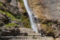 People rappelling in an impressive waterfall