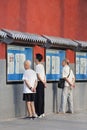 People read newspaper outside, Beijing, China