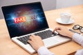 People reading fake news or HOAX on internet content via laptop. Royalty Free Stock Photo