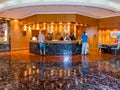 People at reception desk in hotel lobby in Dubai