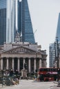 People and red double decker bus on a road in front of Bank of England, London, UK Royalty Free Stock Photo