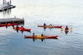 People in red double kayaks at the pier, waiting to explore Frenchman Bay during a sunny summer late afternoon