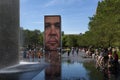 People refreshing at the Crown Fountain in a summer day, in the Millennium Park in the city of Chicago