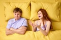 people, relationship difficulties and family concept - unhappy couple having conflict in bed at home, male ignoring wife Royalty Free Stock Photo