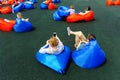 People relax on the bag-bob in the space for recreation. In the foreground, a man and a woman hold a smartphone in their hands.