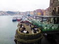 People relax in a cafe on the waterfront in the historic Ribeira district. Porto, Portugal
